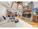 Open concept living room with a stone fireplace, hardwood floors, and a view of the kitchen at 1009 Linenhall Way, Wake Forest, NC 27587