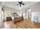 Spacious main bedroom showcases hardwood floors, ceiling fan, and decorative wainscoting at 1009 Linenhall Way, Wake Forest, NC 27587