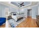 Light and airy main bedroom with hardwood floors, a tray ceiling, and a seating area at 1009 Linenhall Way, Wake Forest, NC 27587