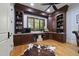 Executive office with custom wood built-ins, hardwood floors, and a comfortable leather chair at 1009 Linenhall Way, Wake Forest, NC 27587