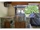 Well-equipped outdoor kitchen with stone facade, stainless steel grill, and sink, ideal for outdoor culinary experiences at 1009 Linenhall Way, Wake Forest, NC 27587