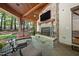 Inviting outdoor living space with a stone fireplace and comfortable seating for relaxing and enjoying the scenery at 1009 Linenhall Way, Wake Forest, NC 27587