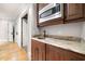Elegant wet bar features granite countertops, a microwave, and stylish wood cabinets at 1009 Linenhall Way, Wake Forest, NC 27587