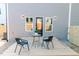 Inviting backyard with a wooden deck, table with two chairs, and exterior lighting at 109 S Plum St, Durham, NC 27703