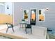 Outdoor deck with two chairs, a table with decor, and a door leading into the home at 109 S Plum St, Durham, NC 27703