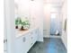 Bright bathroom featuring a double vanity with quartz countertops, and a glass-enclosed tiled shower at 109 S Plum St, Durham, NC 27703
