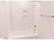 Bright bathroom featuring a tub with white tiled walls and a shower with a silver showerhead at 109 S Plum St, Durham, NC 27703