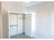 Bright bedroom featuring a ceiling fan, closet, and window at 109 S Plum St, Durham, NC 27703