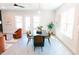 Dining room with a modern table and chairs, natural light, and hardwood flooring at 109 S Plum St, Durham, NC 27703