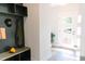 Mudroom area upon entry with a dark built-in shelf, bench, and door to the outside at 109 S Plum St, Durham, NC 27703