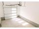 Spacious garage with an automatic door, concrete floor, and block foundation walls at 109 S Plum St, Durham, NC 27703