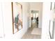 Hallway with a large framed abstract painting, light wood floors, and a view to the living area at 109 S Plum St, Durham, NC 27703