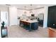Open kitchen with white cabinets, stainless steel appliances, and a central island with seating at 109 S Plum St, Durham, NC 27703