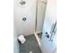 Modern shower featuring sleek fixtures, stone floors, and stylish glass door at 109 S Plum St, Durham, NC 27703