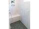 Bright shower with modern grey tiling, stone floors, and built-in bench at 109 S Plum St, Durham, NC 27703