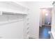 Spacious walk-in closet leads to a bathroom with a glass-enclosed shower at 109 S Plum St, Durham, NC 27703