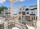 Private balcony with seating offers views of the charming neighborhood townhomes at 11549 Helmond Way # 103, Raleigh, NC 27617