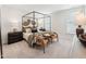 Bedroom with dark wood accents, a striking black four-poster bed, and ample natural light at 11549 Helmond Way # 103, Raleigh, NC 27617