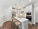 Modern kitchen with stainless steel appliances, a white quartz countertop island, and stylish pendant lighting at 11549 Helmond Way # 103, Raleigh, NC 27617