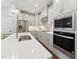 Bright kitchen with modern appliances, an island with a gold faucet, and wooden floor at 11549 Helmond Way # 103, Raleigh, NC 27617