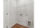 A blank laundry room with a white door and white walls at 11549 Helmond Way # 103, Raleigh, NC 27617