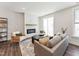Bright living room featuring a modern fireplace, wood floors, and comfortable seating near a sliding glass door at 11549 Helmond Way # 103, Raleigh, NC 27617