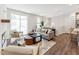 Cozy living room with a large sliding glass doors, wood floors, and comfortable seating at 11549 Helmond Way # 103, Raleigh, NC 27617