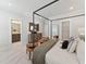 Spacious main bedroom featuring a four poster bed, sitting area and ensuite bathroom at 11549 Helmond Way # 103, Raleigh, NC 27617