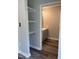 Hallway featuring shelving leads into a bathroom with a stylish vanity and modern flooring at 1165 John Mitchell Rd, Youngsville, NC 27596