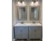 Bathroom features a double vanity with gray cabinets, white countertops, and framed mirrors at 1165 John Mitchell Rd, Youngsville, NC 27596