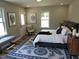 Bedroom featuring a cozy queen-size bed, a large rug, and bright natural light from the window at 1165 John Mitchell Rd, Youngsville, NC 27596
