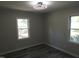 This bedroom features two windows, neutral paint and modern flooring at 1165 John Mitchell Rd, Youngsville, NC 27596