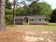 Exterior view of a house featuring light blue siding, a dark door, and small new wooden decks at 1165 John Mitchell Rd, Youngsville, NC 27596