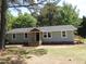 View of the exterior, featuring light blue siding, black door, nice windows, and new wooden decks at 1165 John Mitchell Rd, Youngsville, NC 27596