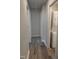 This hallway has neutral paint, modern flooring and a washer/dryer stackable unit at 1165 John Mitchell Rd, Youngsville, NC 27596