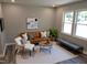 Bright living room with a modern decor and comfortable seating arrangements by large windows at 1165 John Mitchell Rd, Youngsville, NC 27596