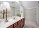 Bathroom featuring double doors, a large vanity with a vintage lamp, and bright lighting at 12 Innisfree Dr, Durham, NC 27707