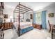 Elegant bedroom with a canopy bed, wooden chest, light blue curtains, and bright natural lighting at 12 Innisfree Dr, Durham, NC 27707