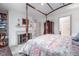 Spacious bedroom featuring a four-poster bed, fireplace, wooden furniture, and neutral color palette at 12 Innisfree Dr, Durham, NC 27707