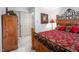 Comfortable bedroom with wooden furniture, red patterned bedding, and access to the home at 12 Innisfree Dr, Durham, NC 27707