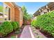 Private brick-lined courtyard with mature landscaping and decorative path lighting at 12 Innisfree Dr, Durham, NC 27707
