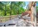 Enjoy outdoor living on this wooden deck with views of lush trees, ideal for relaxation and entertaining at 12 Innisfree Dr, Durham, NC 27707