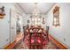 Dining room showcasing a chandelier, custom drapery, and wood flooring at 12 Innisfree Dr, Durham, NC 27707