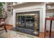 Close up of fireplace featuring a marble hearth, brass fire screen, and built in shelving at 12 Innisfree Dr, Durham, NC 27707