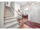 Staircase with elegant foyer and dining room, hardwood floors and chandelier at 12 Innisfree Dr, Durham, NC 27707