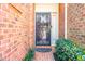 Charming brick home featuring a decorative wrought iron security door at the main entrance at 12 Innisfree Dr, Durham, NC 27707