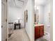 Hallway featuring access to a bathroom with traditional vanity and lighting at 12 Innisfree Dr, Durham, NC 27707