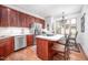 Kitchen featuring updated stainless steel appliances, a breakfast bar, and ample cabinet space at 12 Innisfree Dr, Durham, NC 27707