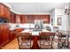 Bright, spacious kitchen features stainless appliances, center island with seating, and adjacent breakfast area at 12 Innisfree Dr, Durham, NC 27707