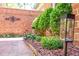 Well-manicured landscaping with neatly trimmed bushes and path lighting bordering a brick walkway at 12 Innisfree Dr, Durham, NC 27707
